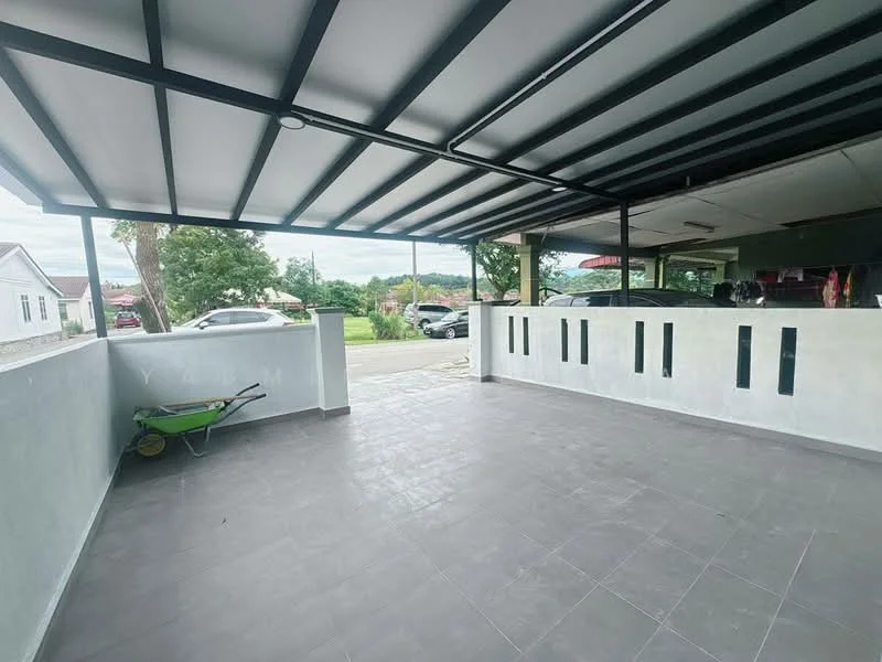 Exterior type: car porch; features: covered car porch with metal roof, grey tiled flooring, concrete walls, open layout, surrounded by greenery, sliding glass door, wheelbarrow visible, driveway access; style: modern.