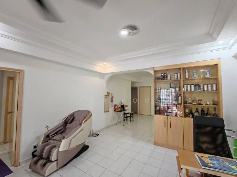 Living features: white painted walls, white tiled flooring, tray ceiling with recessed lighting, ceiling fan, large display cabinet with glass doors, wooden cabinetry, massage chair, dining table with chairs, open layout, natural light from doorway; style: modern.
