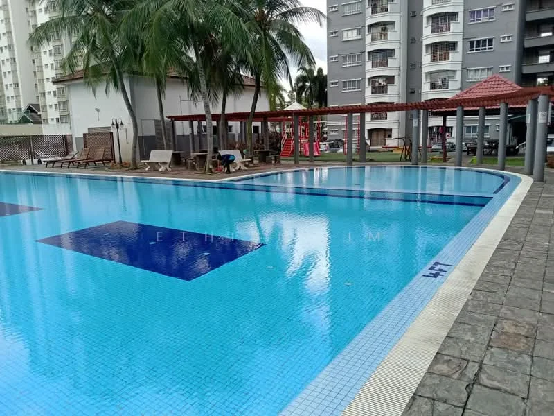 Exterior type: swimming pool deck; features: infinity pool, pool deck with loungers, palm trees, covered seating area, children's playground visible in background, stone-paved walkway, red gazebo structures, poolside lighting, water feature, surrounded by residential buildings; style: modern.