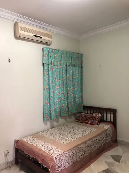 Bedroom features: single bed, floral patterned bedspread, wooden bed frame, window with floral curtains, wall-mounted air conditioning unit, cream painted walls, tile flooring, decorative throw pillows.