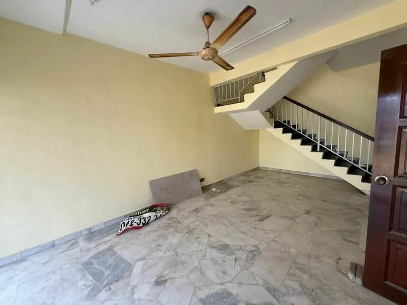 Room features: yellow painted walls, marble flooring, ceiling fan, staircase with metal railing, light fixture on ceiling, open space, corner with debris, natural light from window.