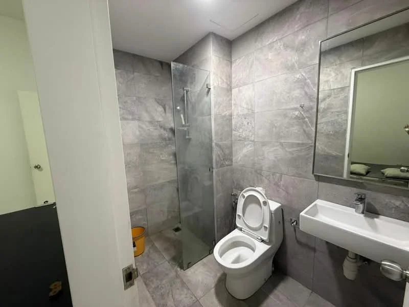 Bathroom features: grey tile flooring, grey tile walls, glass shower enclosure, walk-in shower with handheld shower, single-sink vanity with wall-mounted faucet, framed mirror, one-piece toilet, chrome towel rail; style: modern.