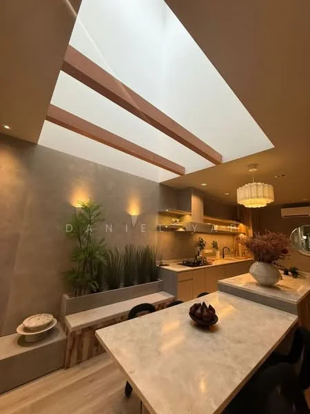 Dining features: marble dining table, upholstered dining chairs, pendant light fixture, skylight, wooden cabinetry, built-in shelving, decorative plants, neutral wall color, recessed lighting, open layout, countertop with storage, kitchen area visible in background; style: modern.