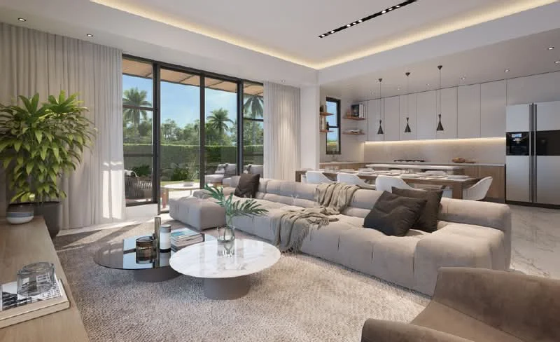 Living features: large sectional sofa in light grey, round coffee table with marble top, area rug with neutral tones, floor-to-ceiling windows, sheer curtains, recessed LED downlights, decorative plant in ceramic pot, wall-mounted shelves, TV console, open layout to dining area, dining table with white chairs, kitchen cabinetry with light wood finish, kitchen island with seating; style: modern; view: garden.