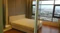 Bedroom features: king-size bed, floor-to-ceiling windows, city view, wooden flooring, sheer curtains, decorative wall panels, built-in wardrobe, recessed lighting; style: modern; view: city.