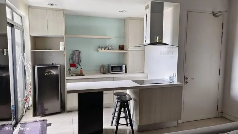 Kitchen features: white cabinetry, grey countertop, stainless-steel fridge, built-in microwave, kitchen island with seating, single-bowl stainless-steel sink, chrome pull-down faucet, ceramic tile flooring, recessed downlights, open shelving, glass backsplash, wall-mounted cabinets; style: modern.