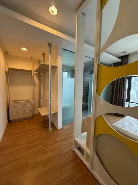 Room features: wood laminate flooring, white painted walls, built-in wardrobe, glass shower enclosure, modern partition with circular cutouts, recessed ceiling lights, large window with curtain, open layout; style: modern; view: city.