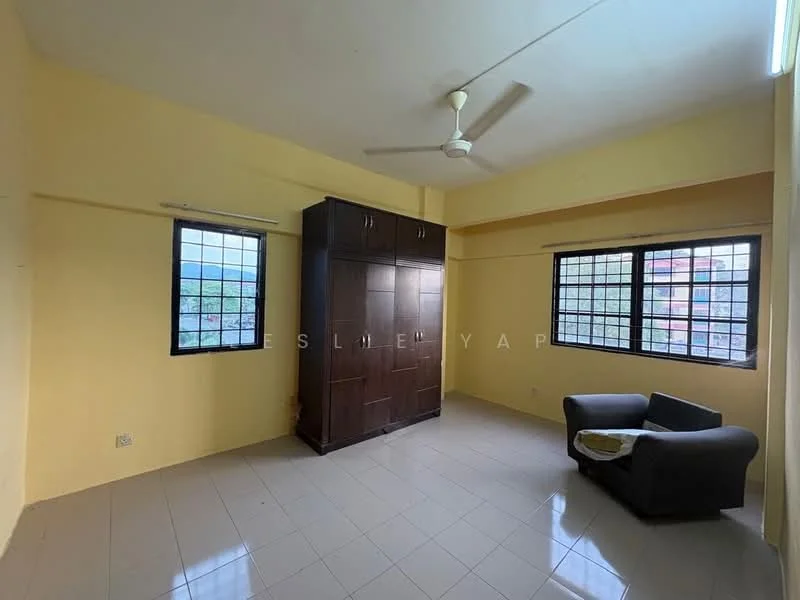 Room features: yellow painted walls, white ceiling, floor-to-ceiling windows, 2 windows with black grills, light-colored tiled flooring, ceiling fan, built-in wardrobe in dark wood, small grey sofa.