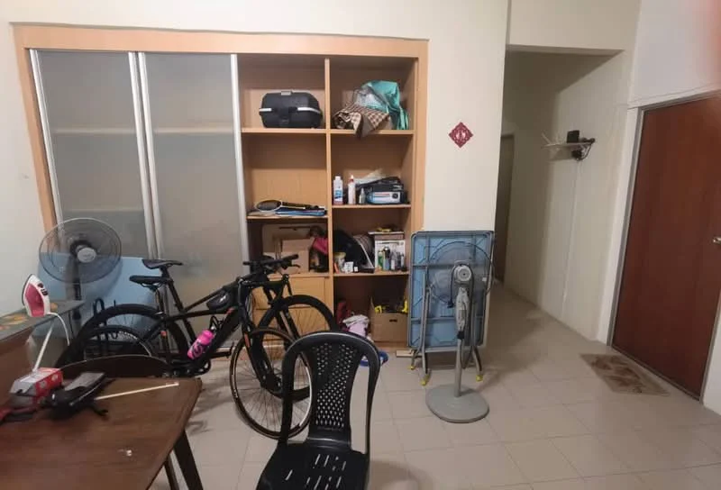 Room features: tile flooring, built-in shelving unit, wooden door, bicycle, desk chair, standing fan, wall-mounted hooks, open space layout.