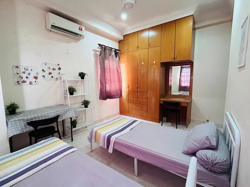 Bedroom features: 2 single beds with grey bedding, wooden wardrobe with multiple doors, study desk with mirror, black chair, white shelving unit, air conditioning unit on wall, curtains in purple, tile flooring, decorative plants on shelves, wall-mounted bulletin board; style: modern.