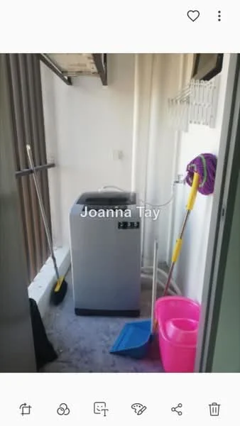 Laundry features: top-load washing machine, mop, broom, dustpan, pink bucket, shelf for storage, white walls, concrete flooring.
