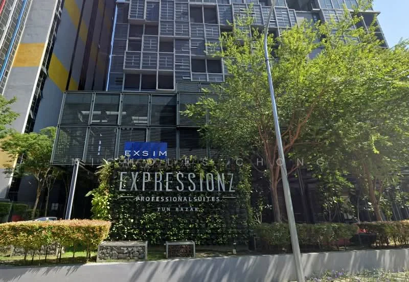 Exterior type: high-rise condominium; features: glass curtain wall, metal cladding, feature signage, landscaped garden, manicured shrubs, street lighting, surrounded by greenery; style: modern.