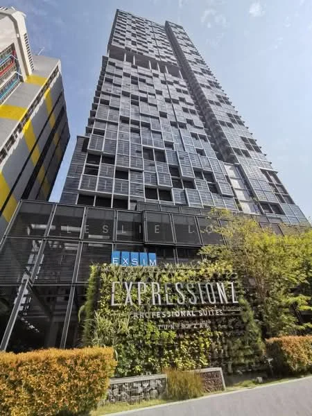 Exterior type: high-rise condominium; features: glass curtain wall, exposed concrete facade, vertical fins, recessed balconies, landscaped greenery at base, signage with 'EXSIM' and 'EXPRESSIONI', surrounded by urban environment; style: modern.