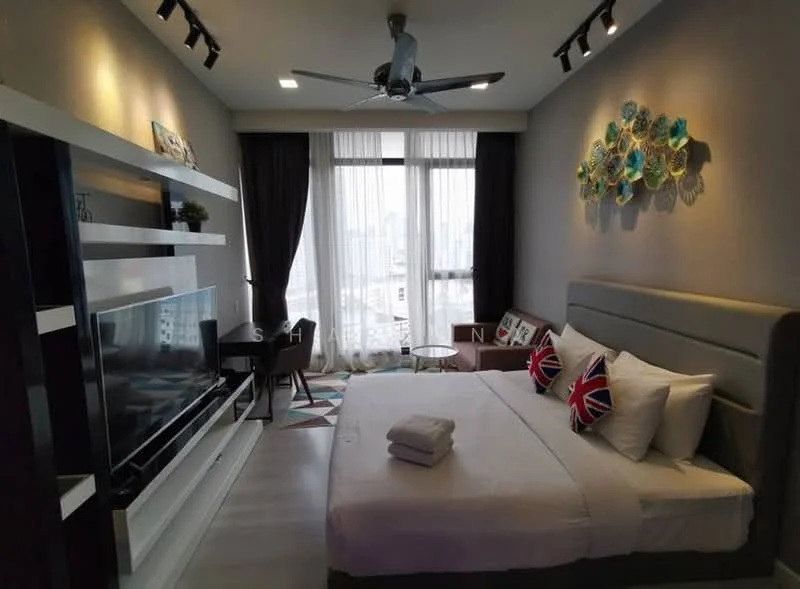 Bedroom features: king-size bed, upholstered headboard, white bedding, decorative pillows with Union Jack pattern, wall-mounted TV, TV console with storage, ceiling fan with light, floor-to-ceiling windows, curtains, area rug with geometric pattern, accent chair, small dining table with chairs; style: modern; view: city.