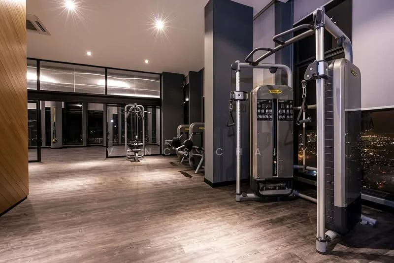 Room features: gym equipment, cardio machines, strength training machines, large windows with city view, wooden flooring, recessed lighting, mirrored wall, modern design, high ceilings, air conditioning unit; style: modern; view: city.