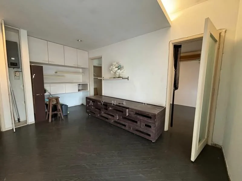 Room features: dark wood flooring, white painted walls, built-in shelving unit, open closet space, wooden console table, door leading to another room, light fixture on ceiling, wall-mounted electrical panel; style: minimalist.