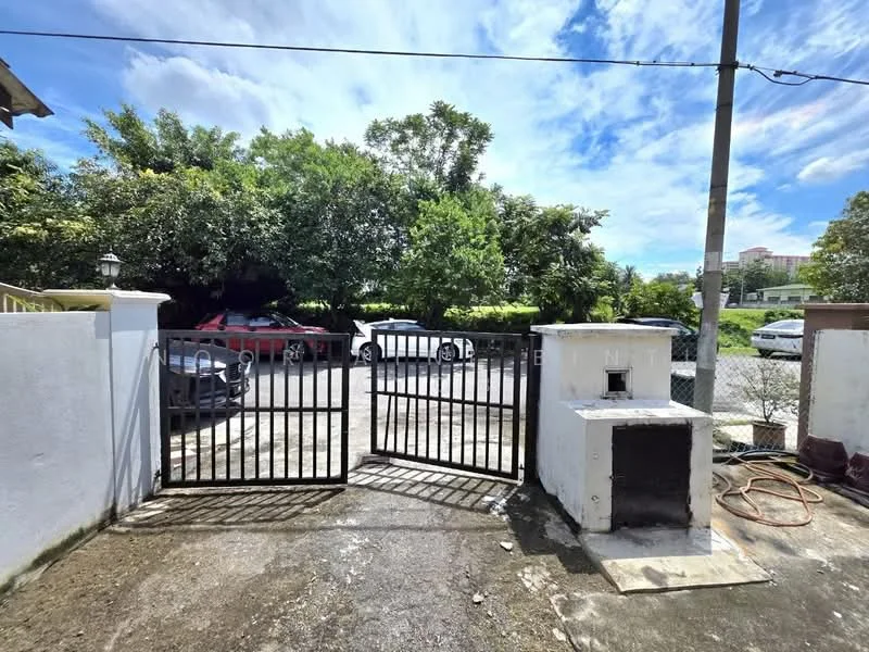 Exterior features: black metal gate, concrete fence, gravel driveway, manicured greenery, parked cars, overhead power lines, clear blue sky, sunlight casting shadows; style: modern.