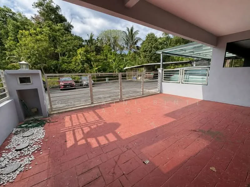 Exterior features: paved red flooring, metal railing, surrounded by greenery, driveway, car parked in driveway, open space, partial roof cover, garden area with stones; style: modern.