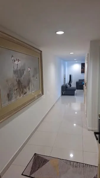 Hallway features: white painted walls, glossy ceramic tile flooring, framed artwork on wall, recessed lighting, area rug with geometric pattern, open space leading to living area, light-colored door frames, television visible in adjacent room; style: modern.