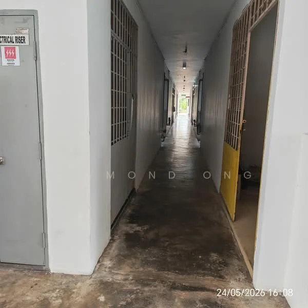 Room features: concrete flooring, white painted walls, metal grilles on windows, interior corridor, doors leading to rooms, lighting fixtures on ceiling, electrical riser cabinet, neutral color scheme; style: modern.