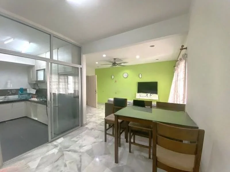 Dining features: green painted walls, marble flooring, ceiling fan, dining table with glass top, 4 wooden dining chairs, wall-mounted TV, decorative wall clock, curtains on windows; style: modern. Kitchen features: glass sliding door, grey cabinetry, stainless-steel sink, countertop with space for appliances, kitchen appliances visible; style: modern.