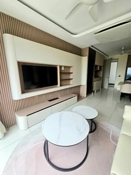 Living features: white marble flooring, light beige accent wall with vertical slats, built-in entertainment unit with TV, floating shelves, two round coffee tables with marble tops, cream-colored sectional sofa, ceiling fan, recessed lighting, large window with sheer curtains, decorative area rug with pink and white pattern; style: modern.