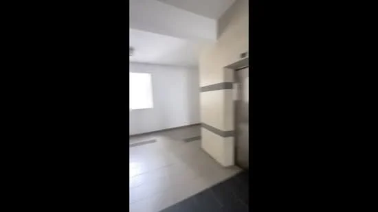 Room features: white painted walls, tile flooring, elevator, window, grey accent strip on wall, ceiling lights; style: modern.