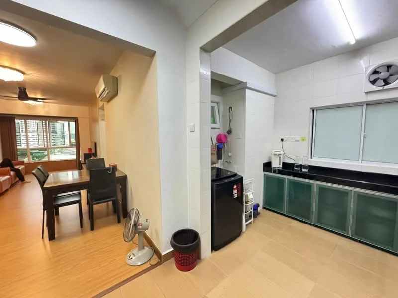 Kitchen features: black countertop, green cabinetry, stainless-steel fridge, built-in sink, exhaust fan, wall-mounted air conditioning unit, tile flooring, window with view, kitchen appliances visible; style: modern. Living features: dining table with four chairs, 3-seater sofa, ceiling fan, wooden flooring, large window, wall-mounted air conditioning unit; style: modern.