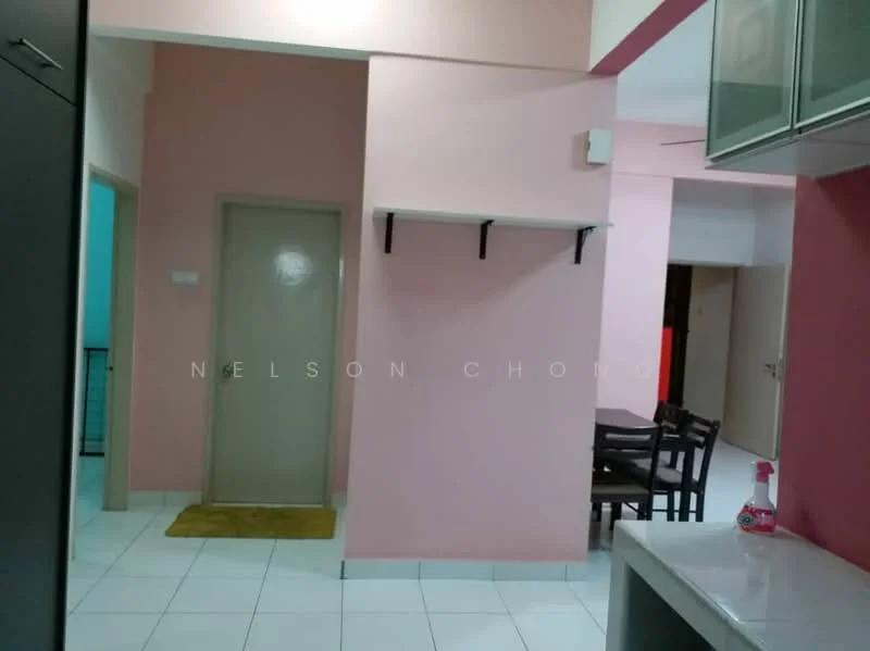 Room features: pink painted walls, white tiled flooring, doorway leading to another room, shelf with black brackets, kitchen cabinetry, dining table with chairs visible in background, yellow doormat.