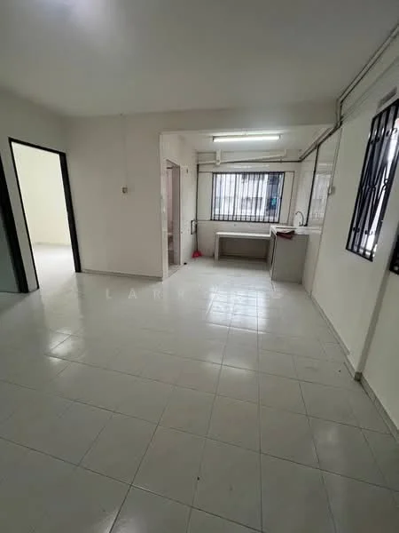 Room features: white painted walls, tile flooring, fluorescent ceiling lights, large window with security bars, kitchen countertop, sink, open layout, doorway leading to another room.