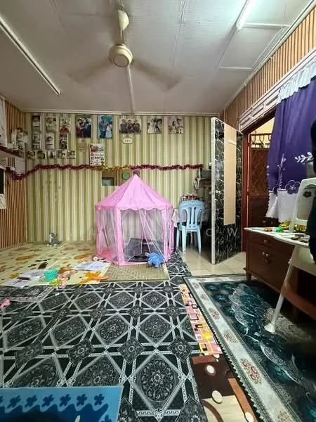 Room features: pink play tent, wooden furniture, blue plastic chair, decorative wall with framed photos, striped wallpaper in green and white, patterned carpet flooring, area rug with geometric pattern, ceiling fan, wall-mounted decorations, various toys on the floor; style: traditional.