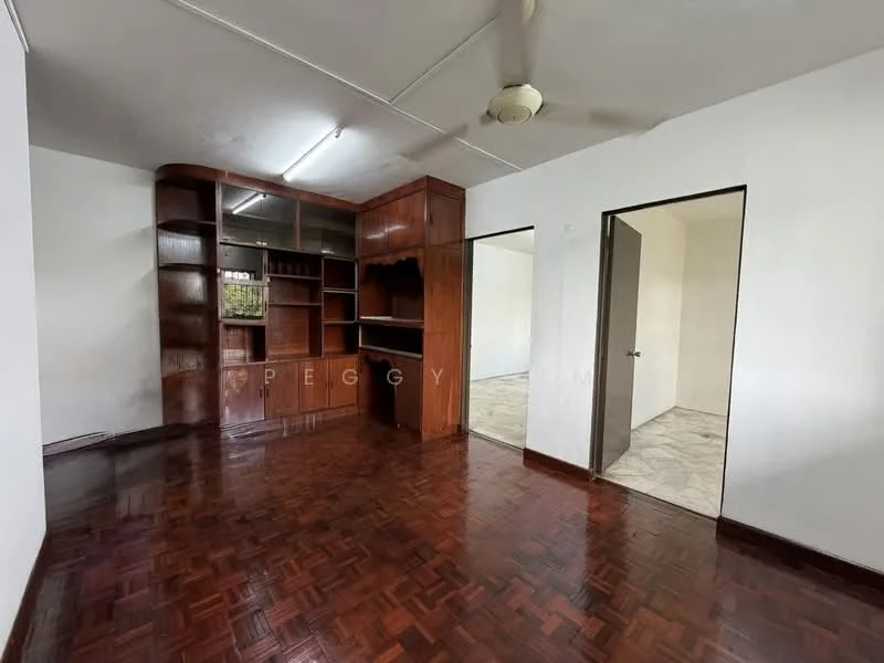 Living features: parquet wood flooring, white painted walls, ceiling fan, built-in wooden shelving unit, doorway leading to another room, doorway leading to bathroom, natural light from window, neutral color scheme.