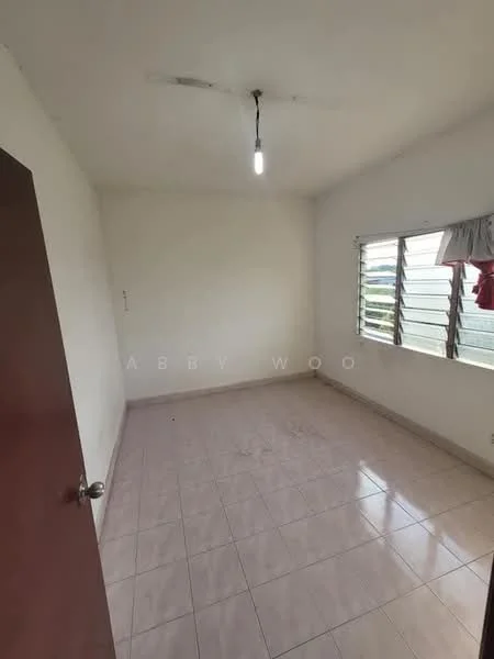 Room features: white painted walls, tile flooring, single light fixture, sliding windows with metal grills, curtains on window, door with handle.