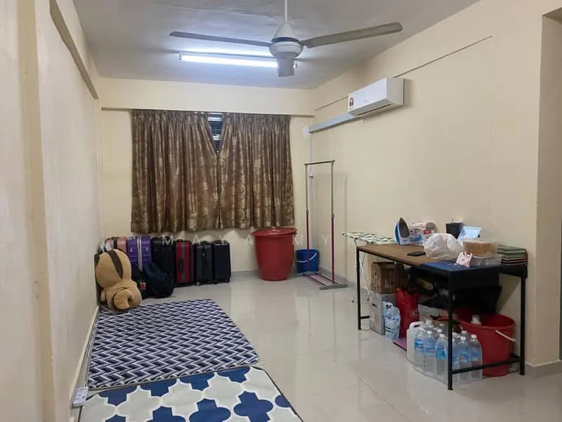 Room features: cream painted walls, glossy tile flooring, ceiling fan, recessed ceiling lights, large window with brown curtains, folding clothes rack, wooden table, plastic storage bins, luggage bags, red plastic bin, water bottles, area rug with geometric pattern, teddy bear.