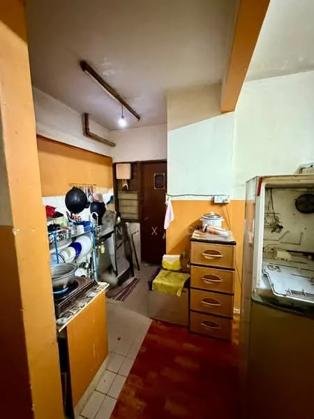 Kitchen features: orange painted walls, tile flooring, wooden cabinetry, stainless-steel sink, freestanding fridge, kitchen countertop, wall-mounted shelves, cooking stove, exposed ceiling beams, window with curtain, light fixture, kitchen utensils on counter.