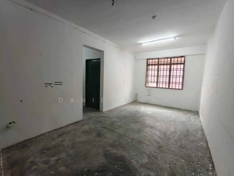 Room features: bare concrete flooring, white painted walls, single window with grid pattern, fluorescent ceiling light, doorway leading to another room.