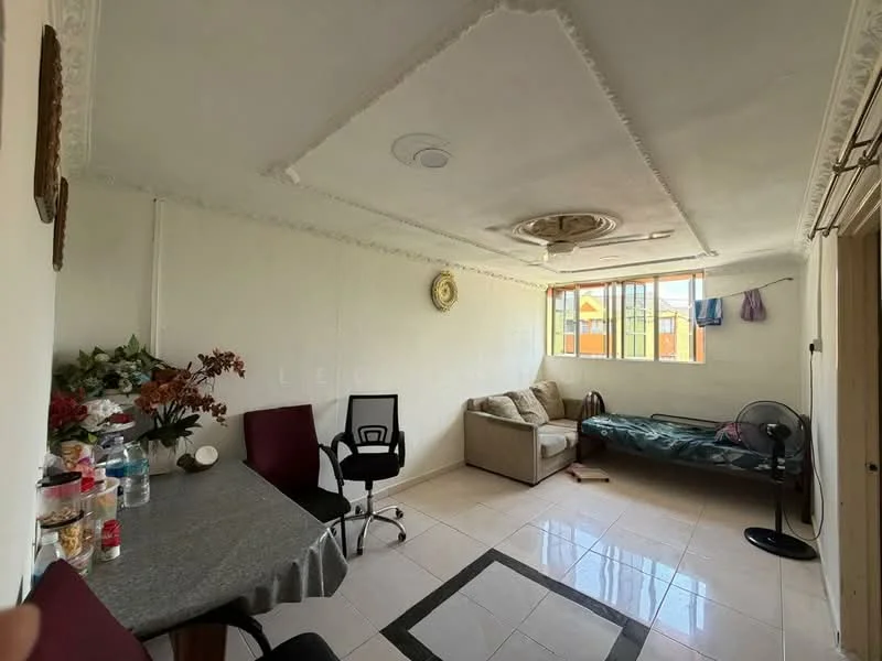 Living features: white painted walls, tray ceiling with decorative molding, ceramic tile flooring, floor-to-ceiling windows, sofa in beige, single bed with bedding, dining table with grey surface, black office chair, fan, decorative wall clock, potted plants; style: modern; view: city.
