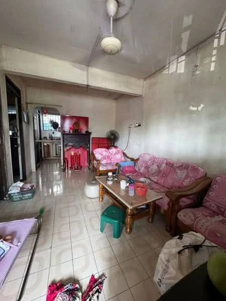Living features: pink floral-patterned sofa, wooden coffee table, green plastic stool, ceiling fan, white tiled flooring, wall-mounted fan, decorative red cabinet, wall-mounted electrical outlets, window with natural light, light-colored painted walls. Room features: open layout to kitchen, dining area visible, additional furniture items.
