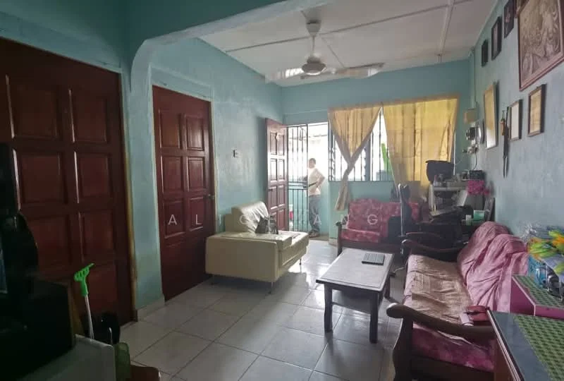 Living features: light blue painted walls, white ceiling, floor tiles, 3-seater fabric sofa in cream, 2-seater fabric sofa in pink, wooden coffee table, wooden armchair, ceiling fan, curtains in yellow, double wooden doors, window with metal grille, decorative wall art; style: traditional.