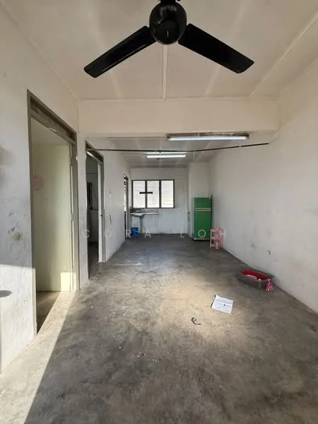 Room features: white painted walls, concrete flooring, ceiling fan, large window, fluorescent ceiling lights, open layout, no visible furniture, natural light from window.