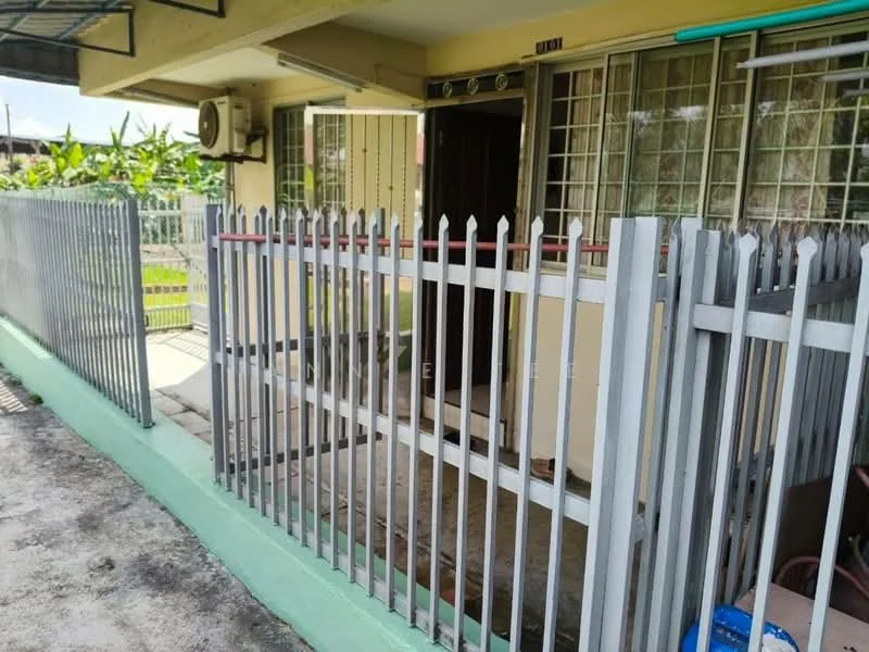 Exterior type: linked terrace house; features: metal fence with pointed tops, concrete pathway, air conditioning unit mounted on wall, front door with security grille, green painted base, outdoor area with plants, visible drainage system; style: modern.