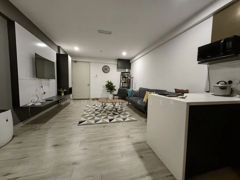 Living features: grey fabric sofa, coffee table, wall-mounted TV, TV console, area rug with geometric pattern, decorative wall panel, wooden shelving unit, recessed downlights, laminate flooring, white painted walls, clock on wall, open kitchen area with countertop, microwave, kitchen appliances; style: modern.