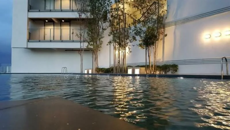 Exterior type: high-rise condominium; features: infinity pool, pool deck, landscaped area with trees, modern lighting fixtures, glass railing, water feature, white painted facade, multiple balconies; style: modern.