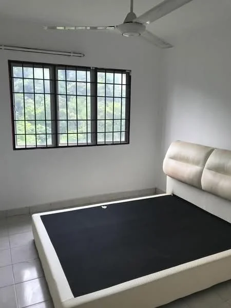 Bedroom features: white painted walls, tile flooring, ceiling fan, large windows with grid pattern, unmade bed with mattress, minimalist headboard, natural light from windows, view of greenery outside; style: minimalist; view: garden.