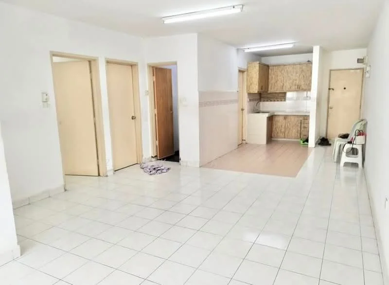 Living features: white painted walls, ceramic tile flooring, recessed ceiling lights, two wooden doors, one open doorway, kitchen area visible, neutral color scheme, no visible furniture. Kitchen features: wood cabinetry, countertop, kitchen appliances visible, tile backsplash, open layout to living area.