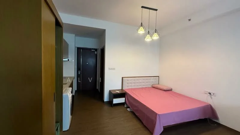 Bedroom features: queen-size bed with pink bedspread, wooden headboard, 3 pendant lights, wooden wardrobe, laminate flooring, white painted walls, window with no visible treatment, door leading to hallway, nightstand, washing machine; style: modern.