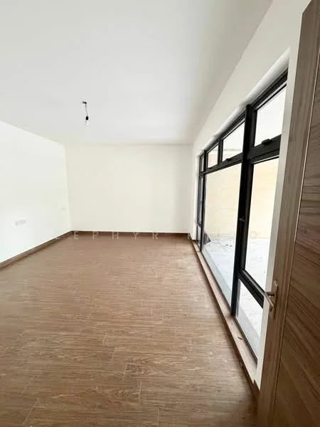 Room features: light wood flooring, white painted walls, large floor-to-ceiling windows, black window frames, single pendant light fixture, door with wood finish; style: modern.