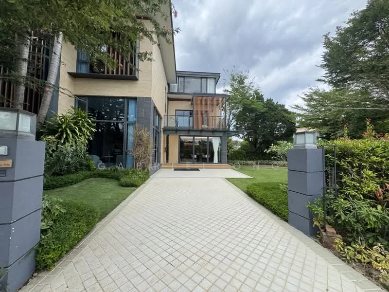 Exterior type: detached bungalow; features: cream painted facade, large glass windows, recessed balconies, manicured lawn, tropical landscaping, stone-paved walkway, two-storey structure, surrounded by greenery; style: modern.