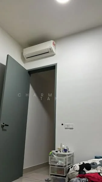 Room features: white painted walls, light grey door, wall-mounted split AC, tile flooring, ceiling light, transparent storage drawers, bed with bedding, decorative items on bed; style: modern.
