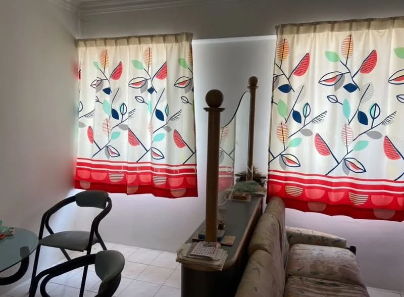 Living features: floral patterned curtains with red trim, light-colored walls, tiled flooring, sofa with floral upholstery, wooden coffee table, two chairs, decorative items on the table.